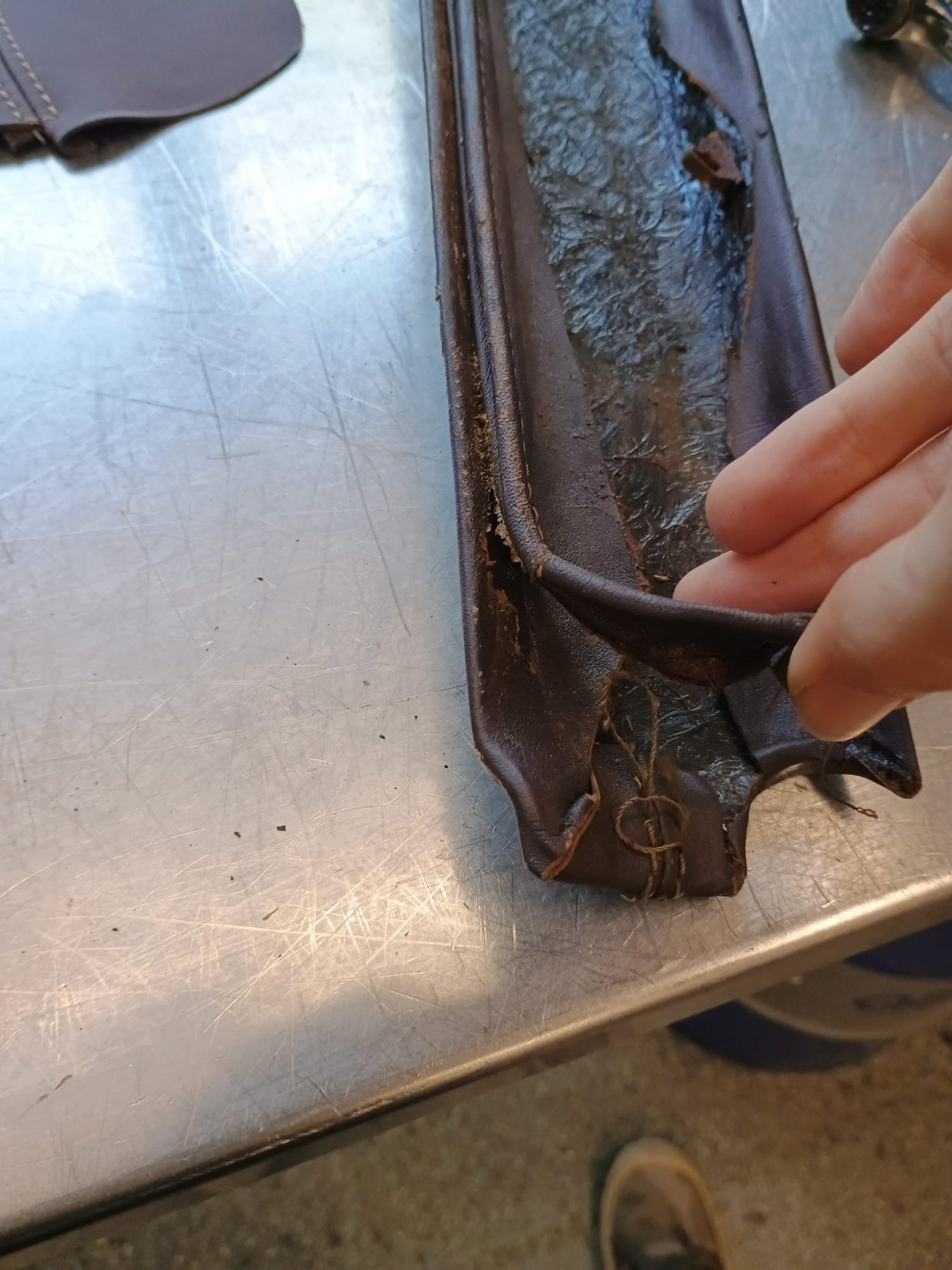 Detail van het versleten leer — scheuren en verdroogde naden